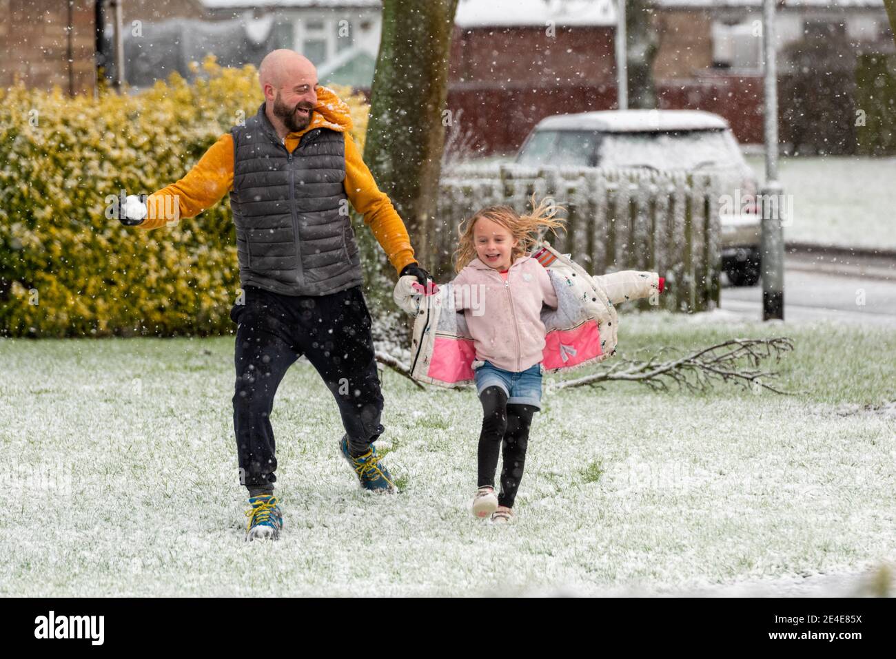 Willingham Cambridgeshire, UK. 23rd Jan, 2021. People enjoy being outside as a heavy snow shower falls in East Anglia in cold winter weather. Further snowfall is forecast across parts of the UK with freezing temperatures over the next few days. Credit: Julian Eales/Alamy Live News Stock Photo