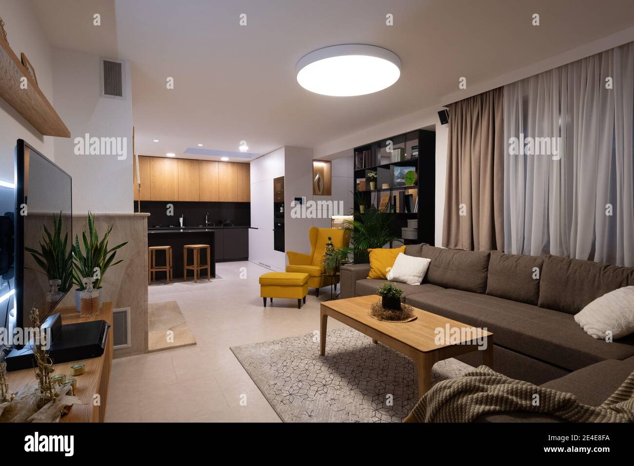 Interior of livingroom connected with kitchen in a modern house Stock