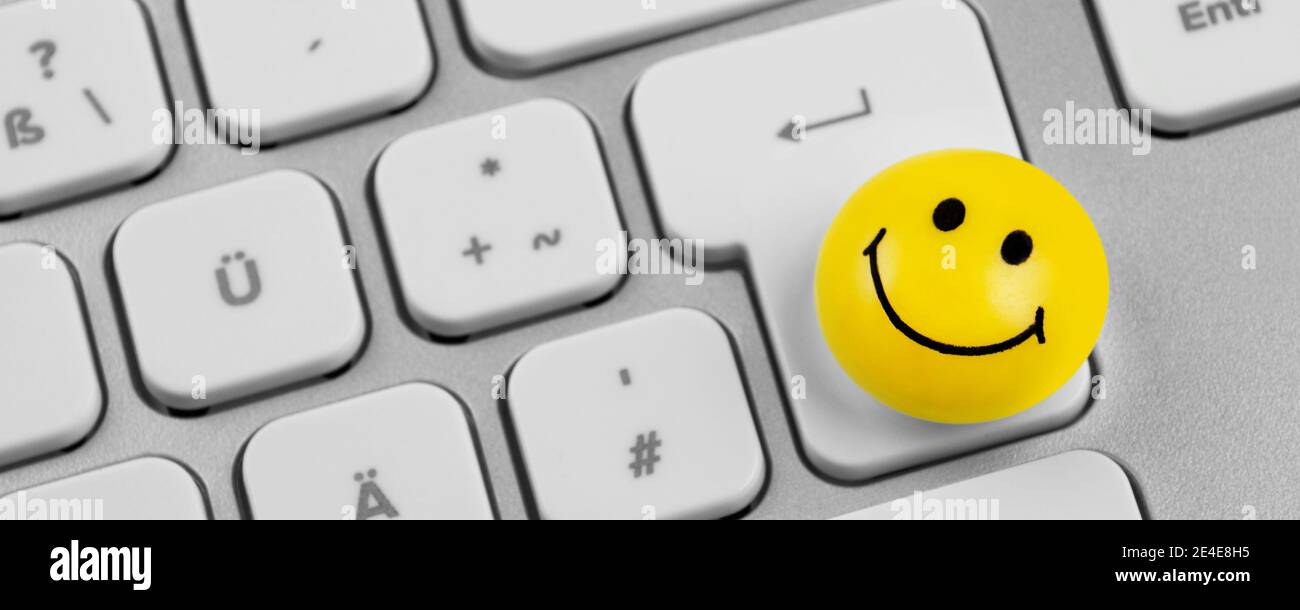 PC keyboard and smiling button Stock Photo