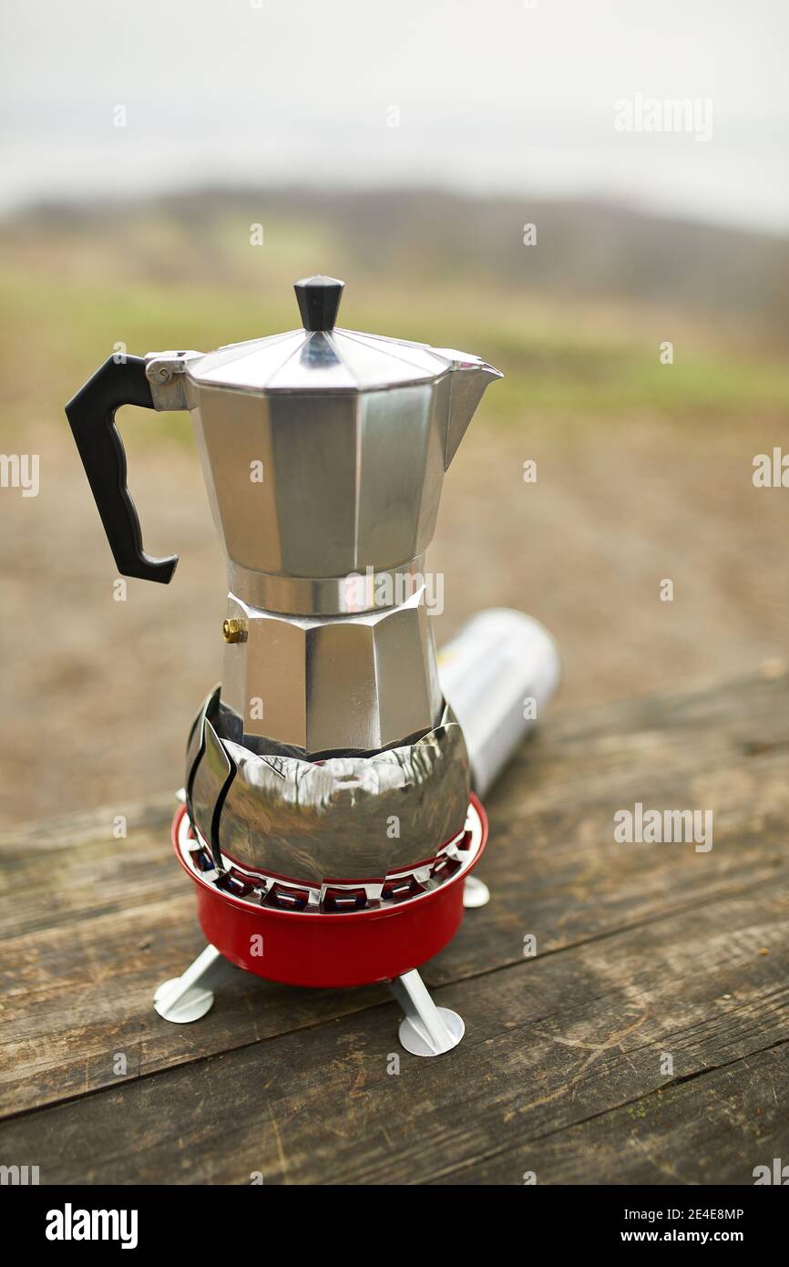 https://c8.alamy.com/comp/2E4E8MP/process-of-making-camping-coffee-outdoor-with-metal-geyser-coffee-maker-on-a-gas-burner-step-by-step-travel-activity-for-relaxing-bushcraft-advent-2E4E8MP.jpg