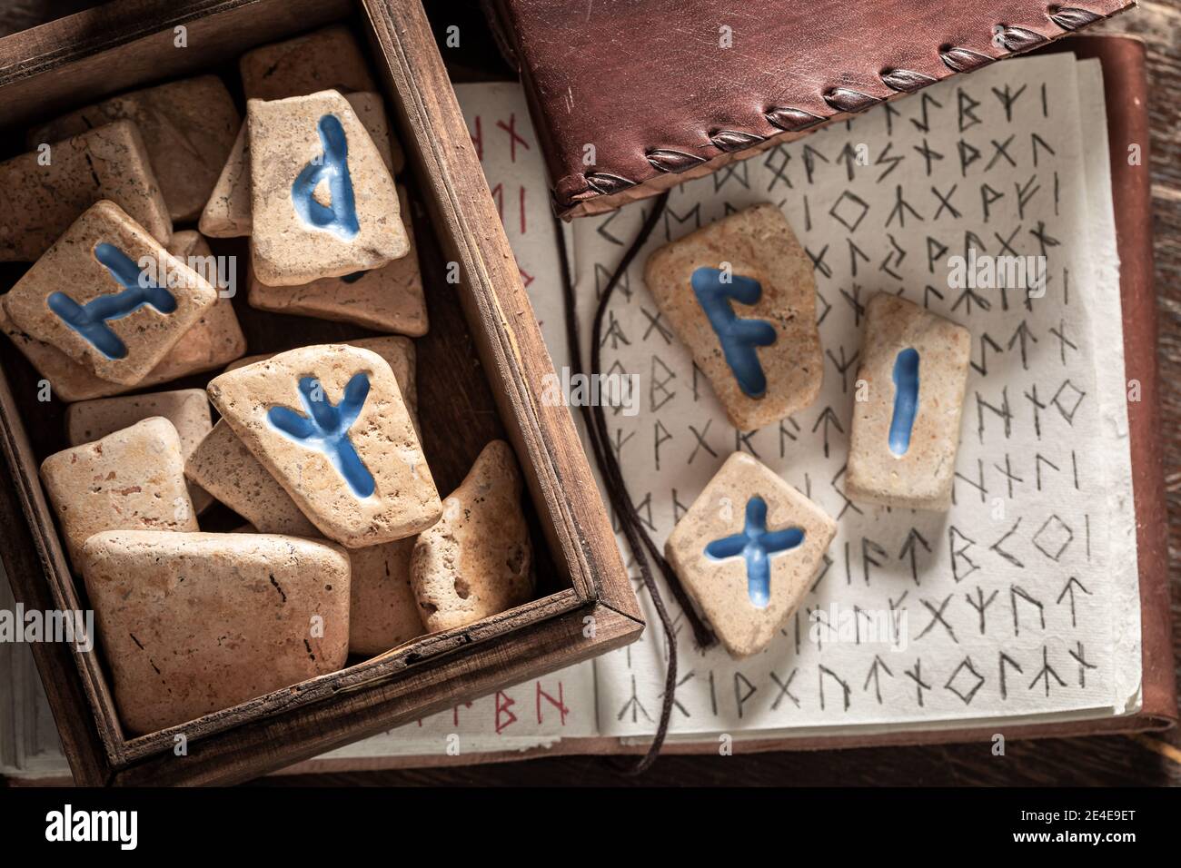 Runic stones and old book with Celtic language on old table Stock Photo ...