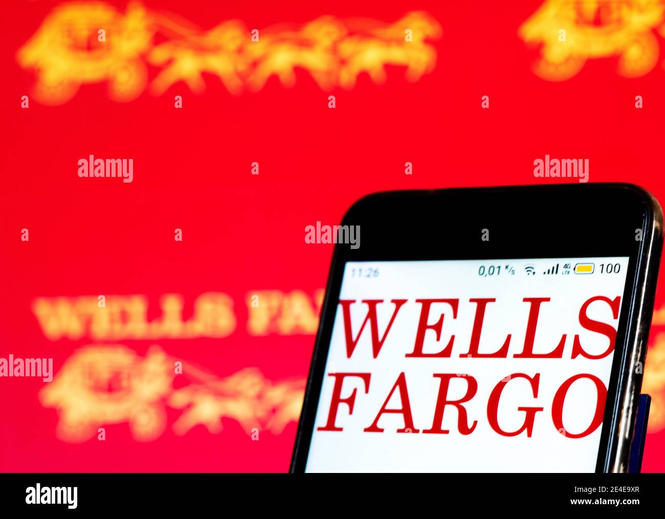 In this photo illustration a Wells Fargo logo seen displayed on smart