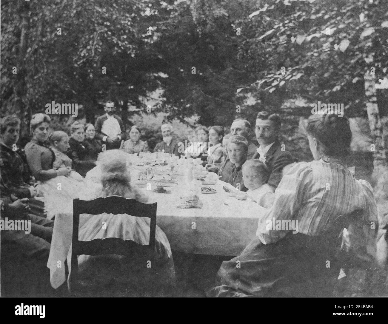 American archive cyanotype portrait of a large family celebration meal at an outdoor table. Taken in the late 19th century in Port Byron, NY, USA Stock Photo
