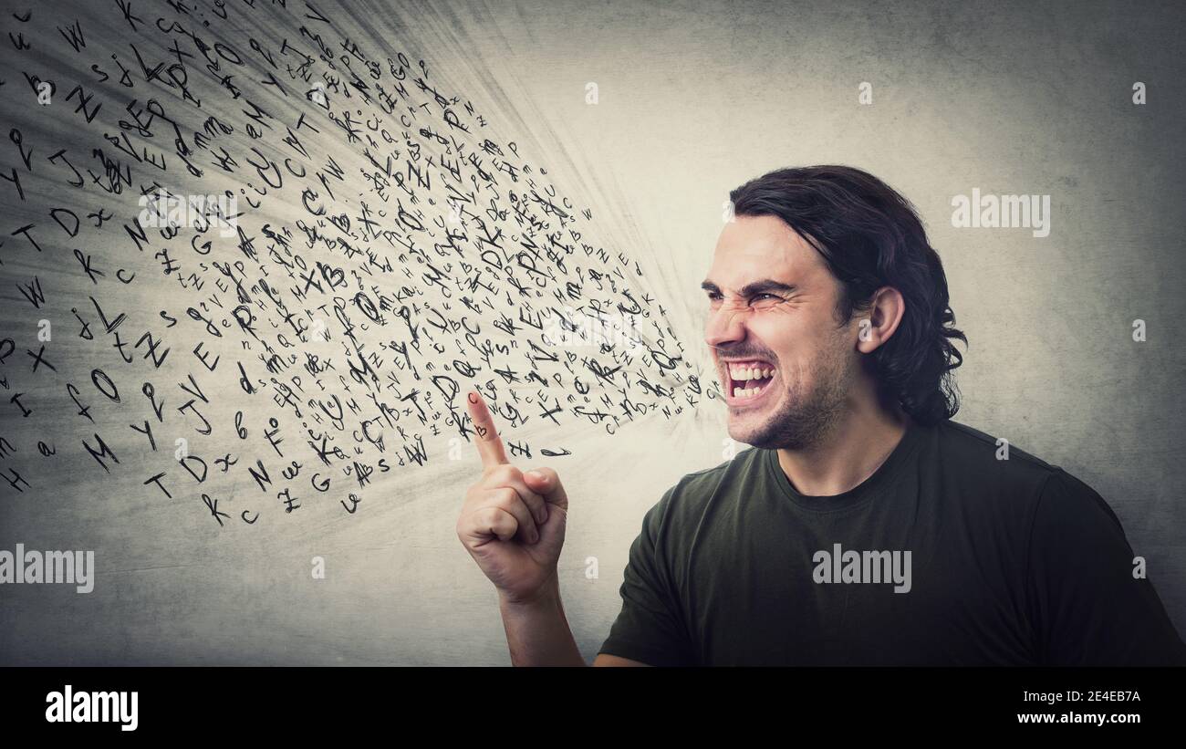 Angry man reacting furious clenching teeth screaming and shaking his index finger. Irritated and annoyed guy negative facial expression, blaming or sc Stock Photo