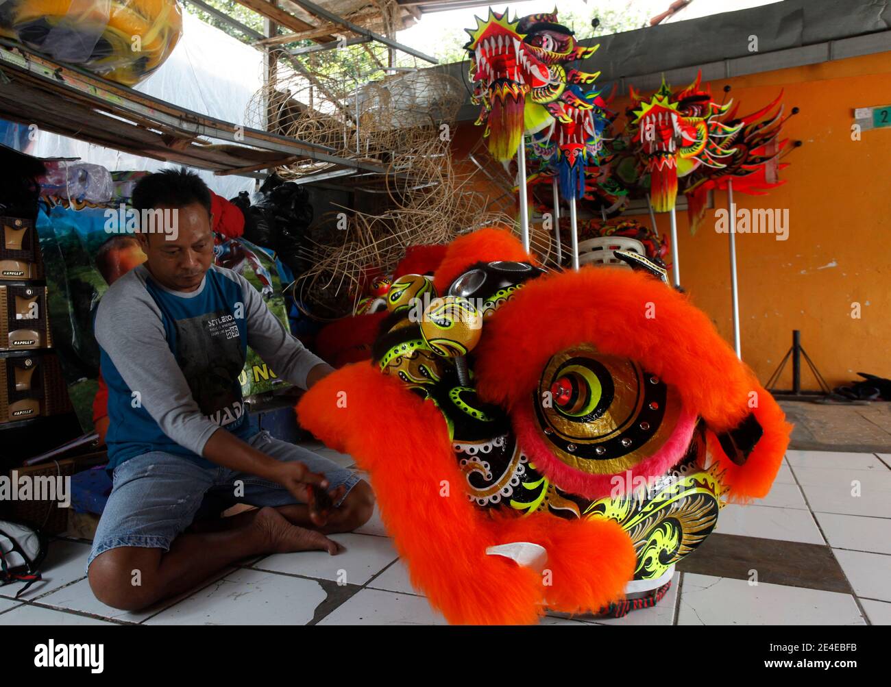 Bogor, Indonesia. 23rd Jan, 2021. A craftsmen maker of lion (Barongsai) and dragon (Liong) dance costumes, inspects his creations inside his house ahead of Lunar New Year celebrations, in Bogor, Indonesia on January 23, 2021. Millions of Chinese around the world will celebrate the Lunar New Year, 2021 is the year of the Ox, which falls on February 12th amid the global coronavirus COVID-19 pandemic. (Photo by Adrian/INA Photo Agency/Sipa USA) Credit: Sipa USA/Alamy Live News Stock Photo