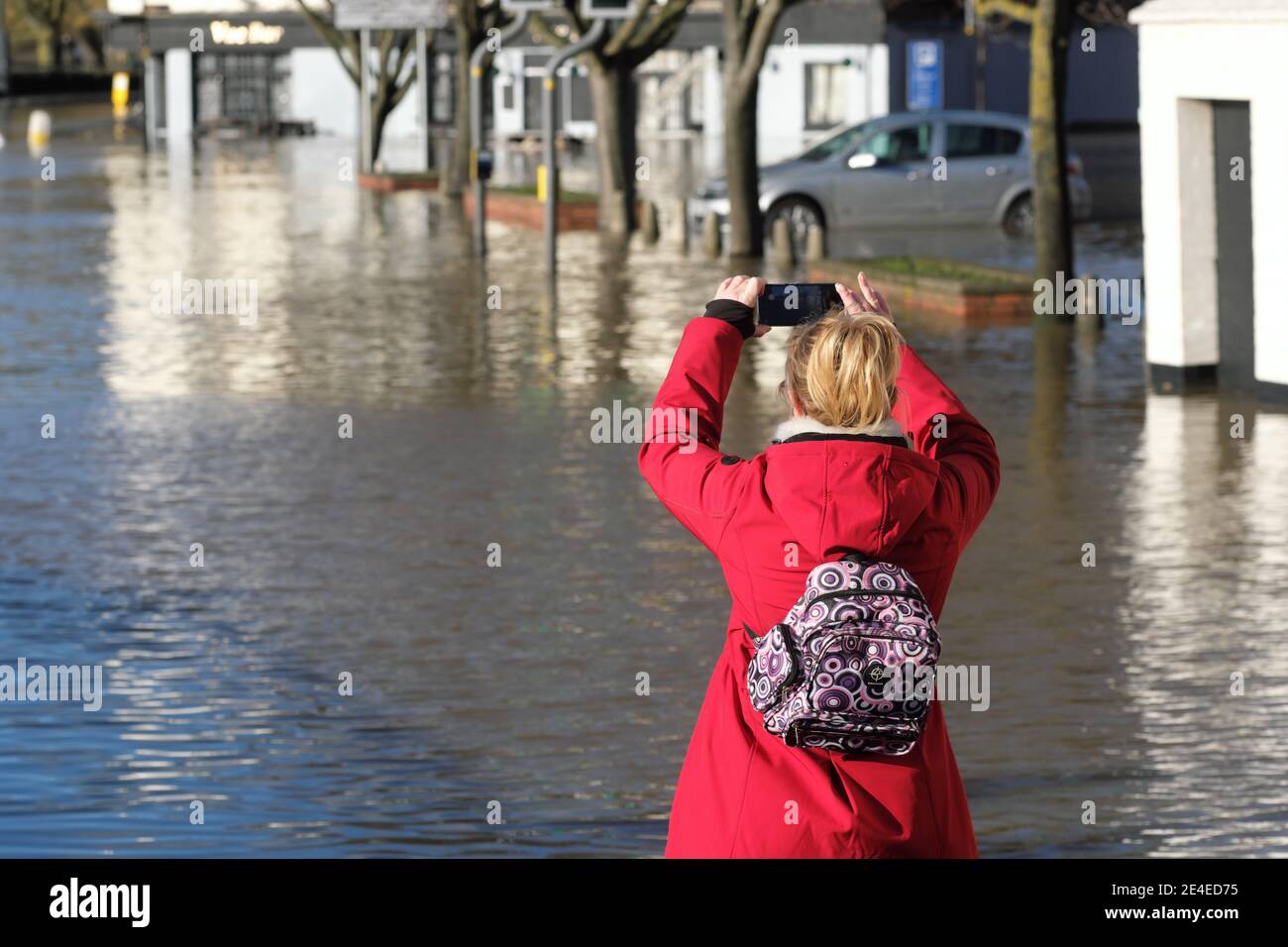 Worcester, Worcestershire, UK - Saturday 23rd January 2021 - Flood tourism, a visitor records the flooding beside the River Severn in the centre of Worcester. The Severn is expected to peak in Worcester later this evening.  Photo Steven May / Alamy Live News Stock Photo