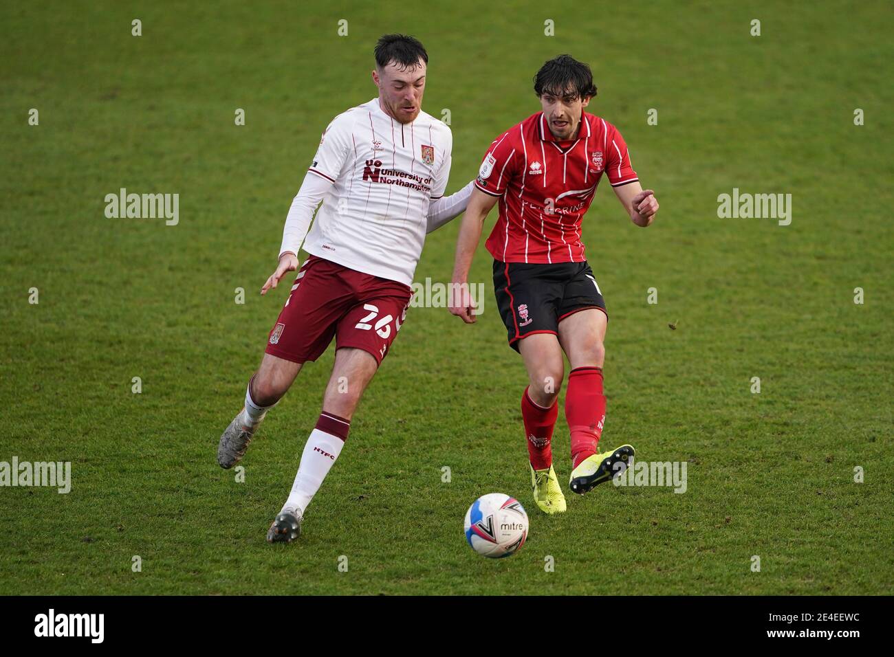 Lincoln City's Joe Walsh (right) and Northampton Town's Ryan Edmondson battle for the ball during the Sky Bet League One match at LNER Stadium, Lincoln. Picture date: Saturday January 23, 2021. Stock Photo