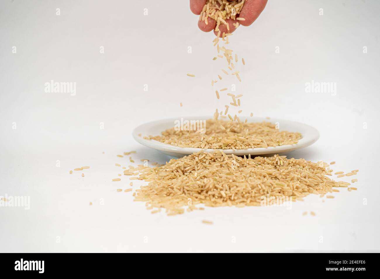 Hand pouring out rice hi-res stock photography and images - Alamy