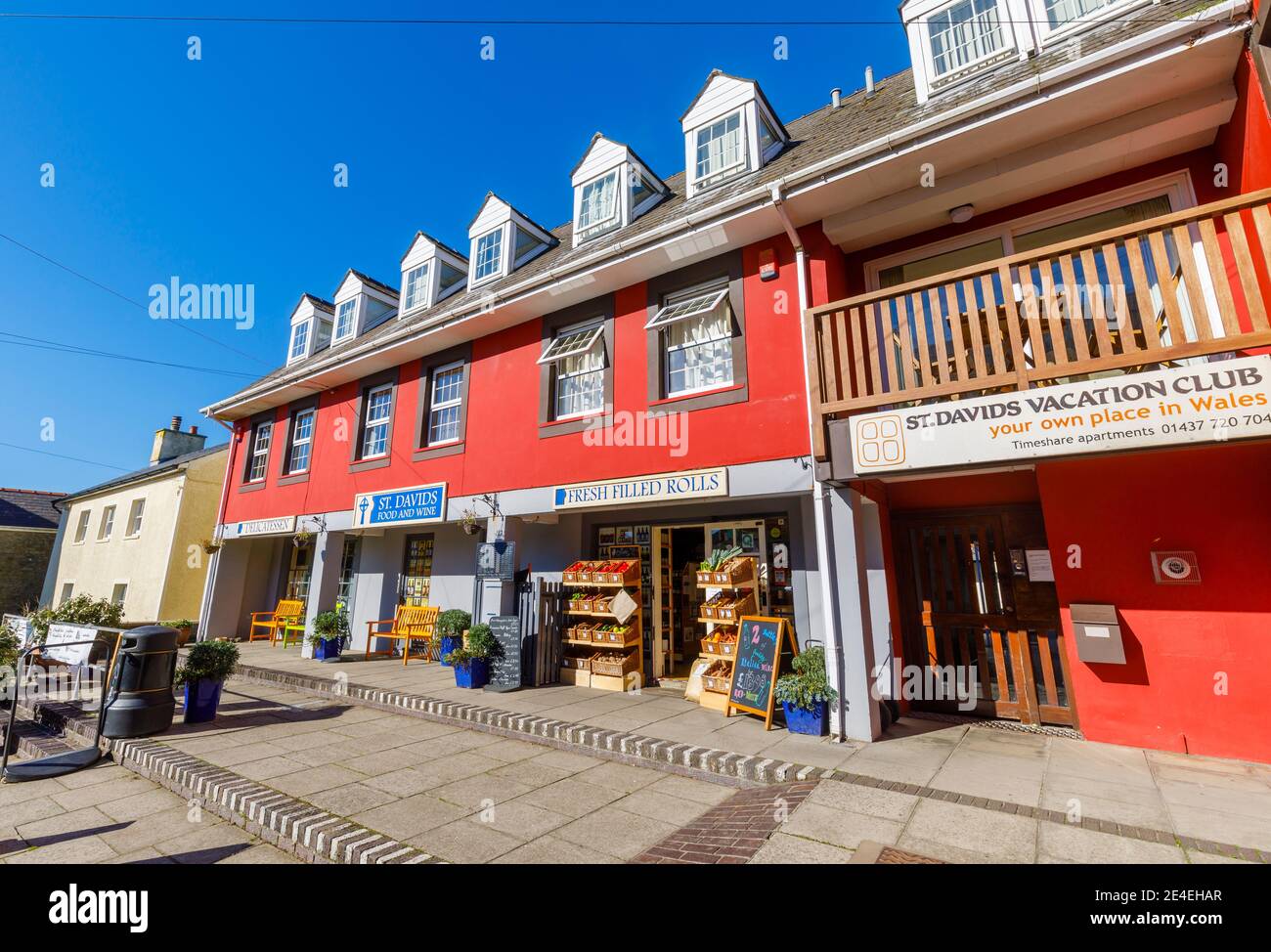 Street scene: a small typical parade of local shops in the main street of St Davids, a small cathedral city in Pembrokeshire, south west Wales Stock Photo