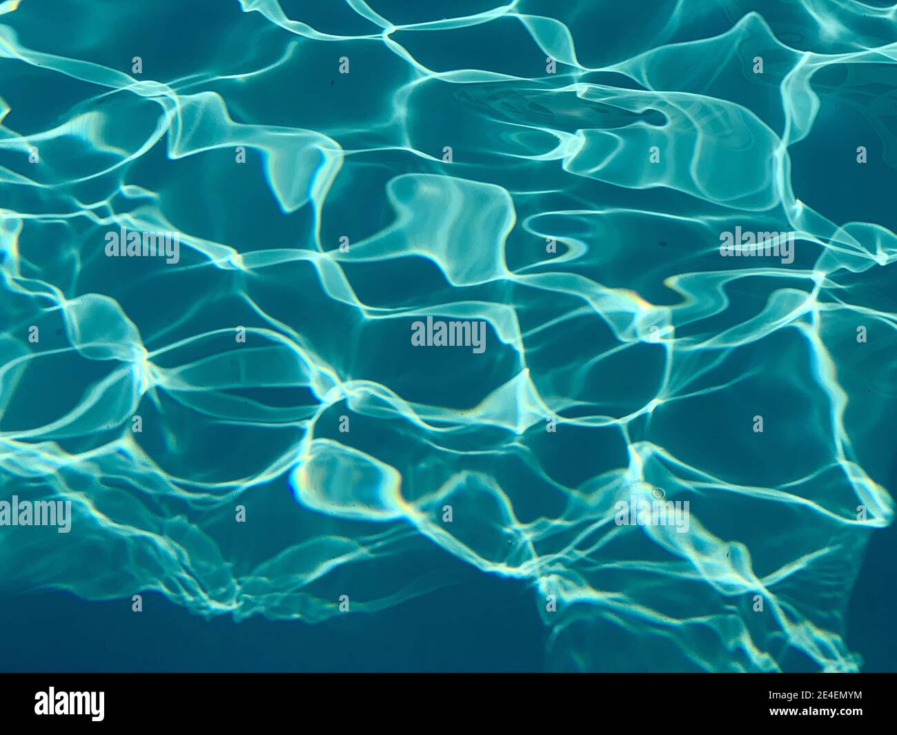Reflection of the sun on the water of a swimming pool perfect for