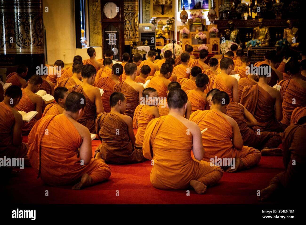 Young monks praying in temple in Thailand Stock Photo