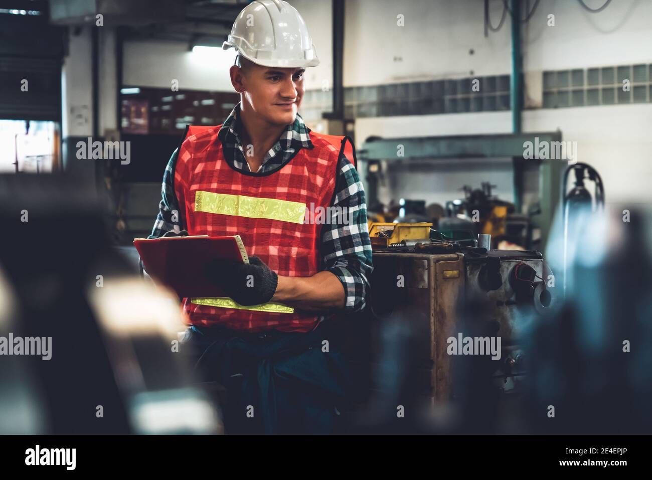 Manufacturing worker working with clipboard to do job procedure