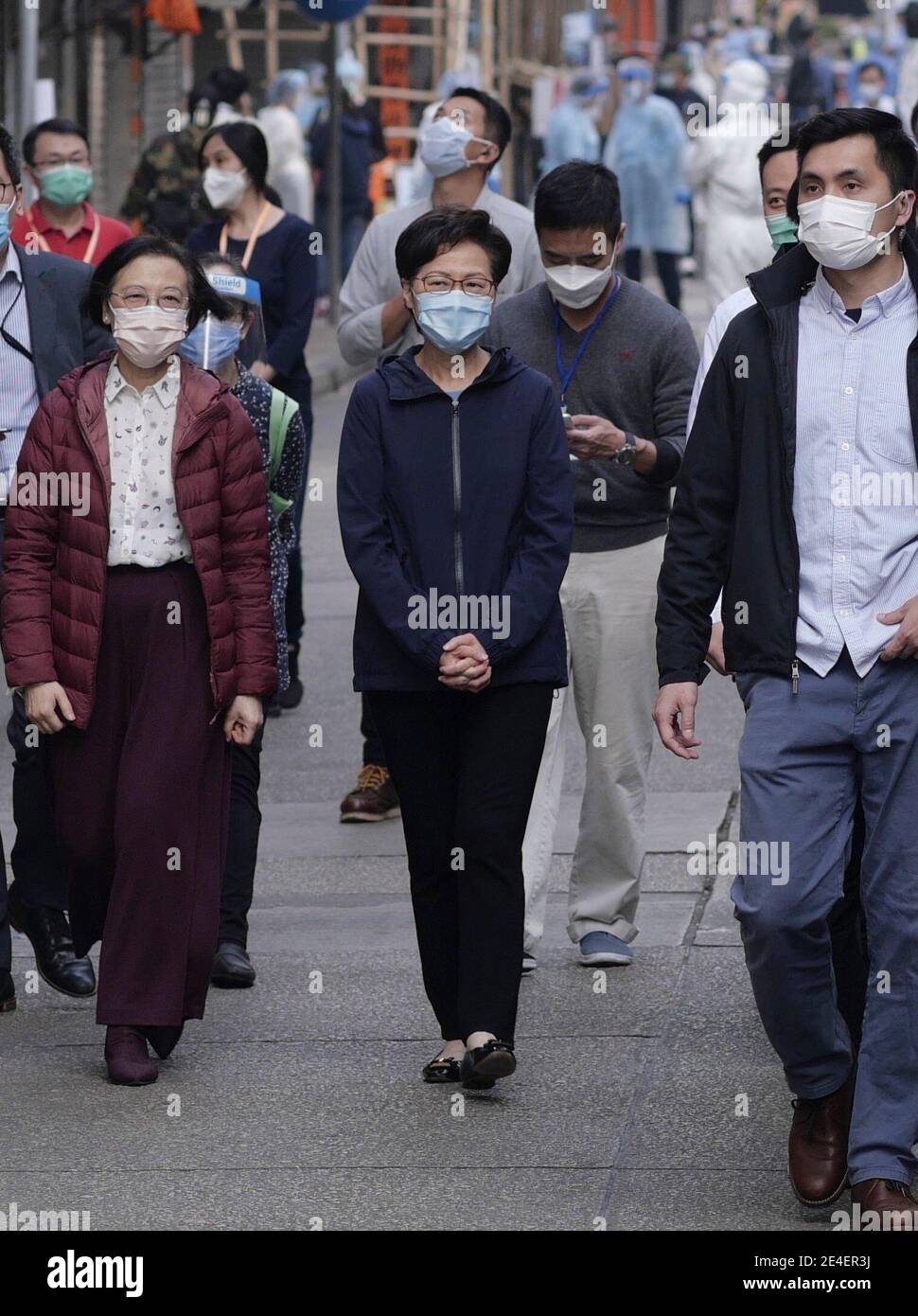 Hong Kong, China. 23rd Jan, 2021. Chief Executive of the Hong Kong Special Administrative Region Carrie Lam (C) inspects compulsory COVID-19 testing in a virus-stricken area in Kowloon, Hong Kong, south China, Jan. 23, 2021. TO GO WITH 'Roundup: A year after 1st case found, Hong Kong's COVID-19 tally surpasses 10,000' Credit: Wang Shen/Xinhua/Alamy Live News Stock Photo