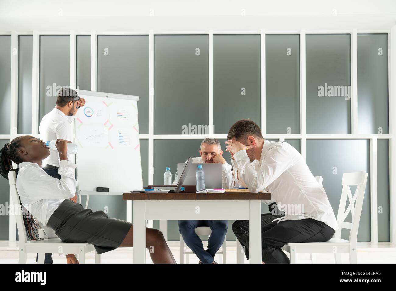 Brainstorm concept. Group of international partners are discussing the project for a long time and looking very tired Stock Photo