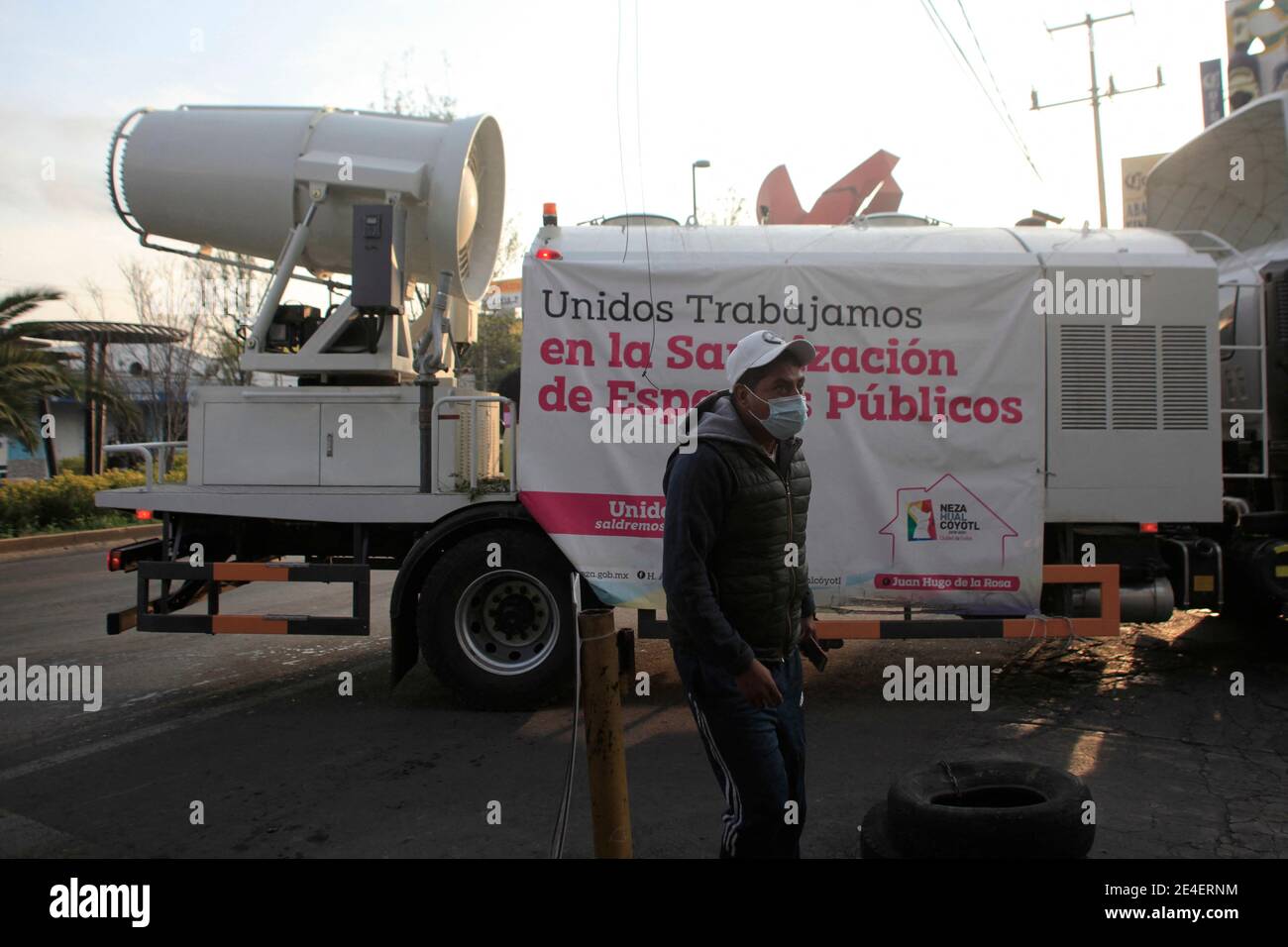 A worker drives an air sanitizer truck with a tank capacity of 9.8 cubic  meters, a