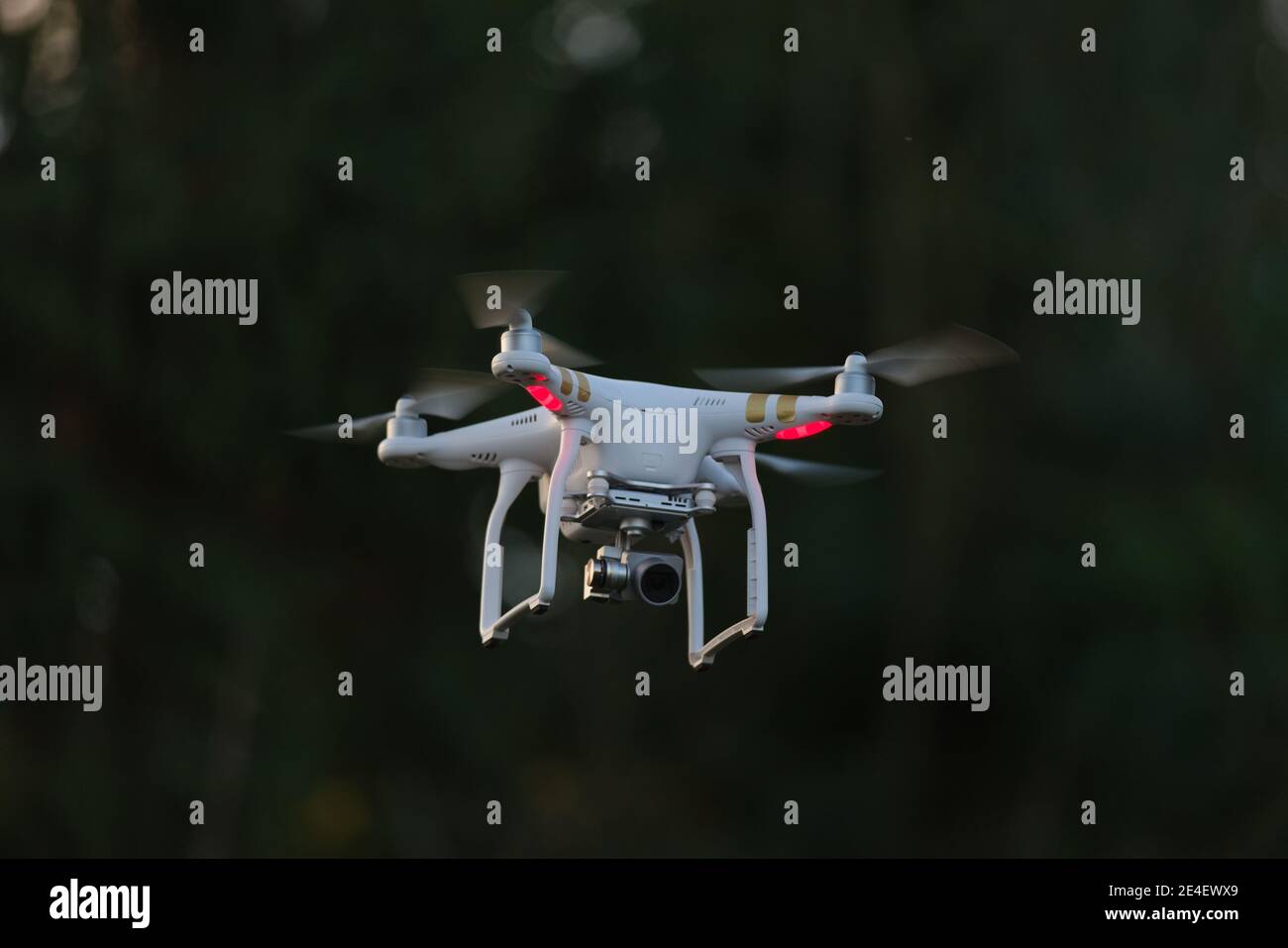 8 - UAV drone copter flying, isolated against plain background. Modern technology in action, used for videography and photography. Stock Photo