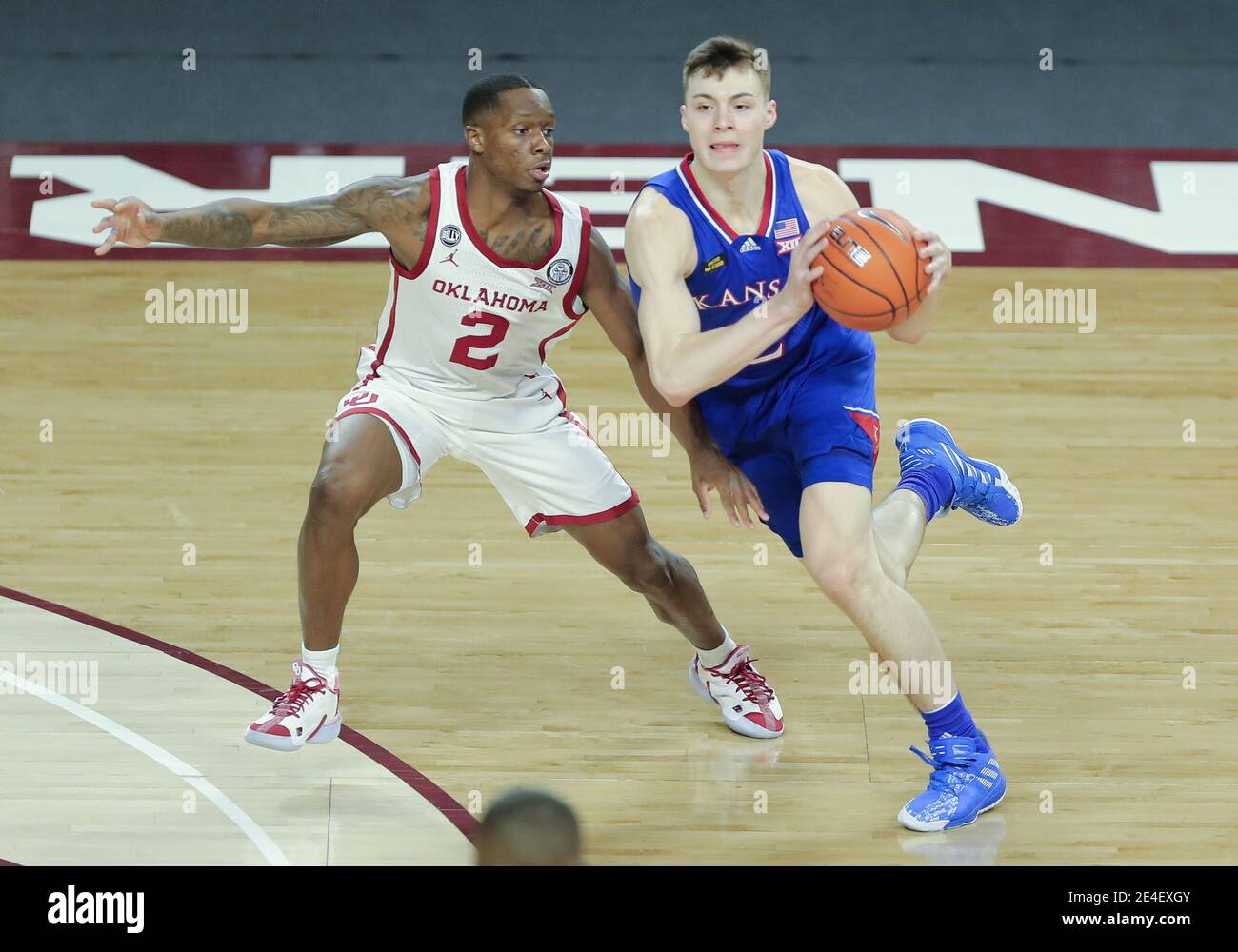 Norman, OK, USA. 23rd Jan, 2021. Kansas Jayhawks guard Christian Braun (2) is defended by Oklahoma Sooners guard Umoja Gibson (2) during a basketball game between the Kansas Jayhawks and Oklahoma Sooners at Lloyd Noble Center in Norman, OK. Gray Siegel/CSM/Alamy Live News Stock Photo