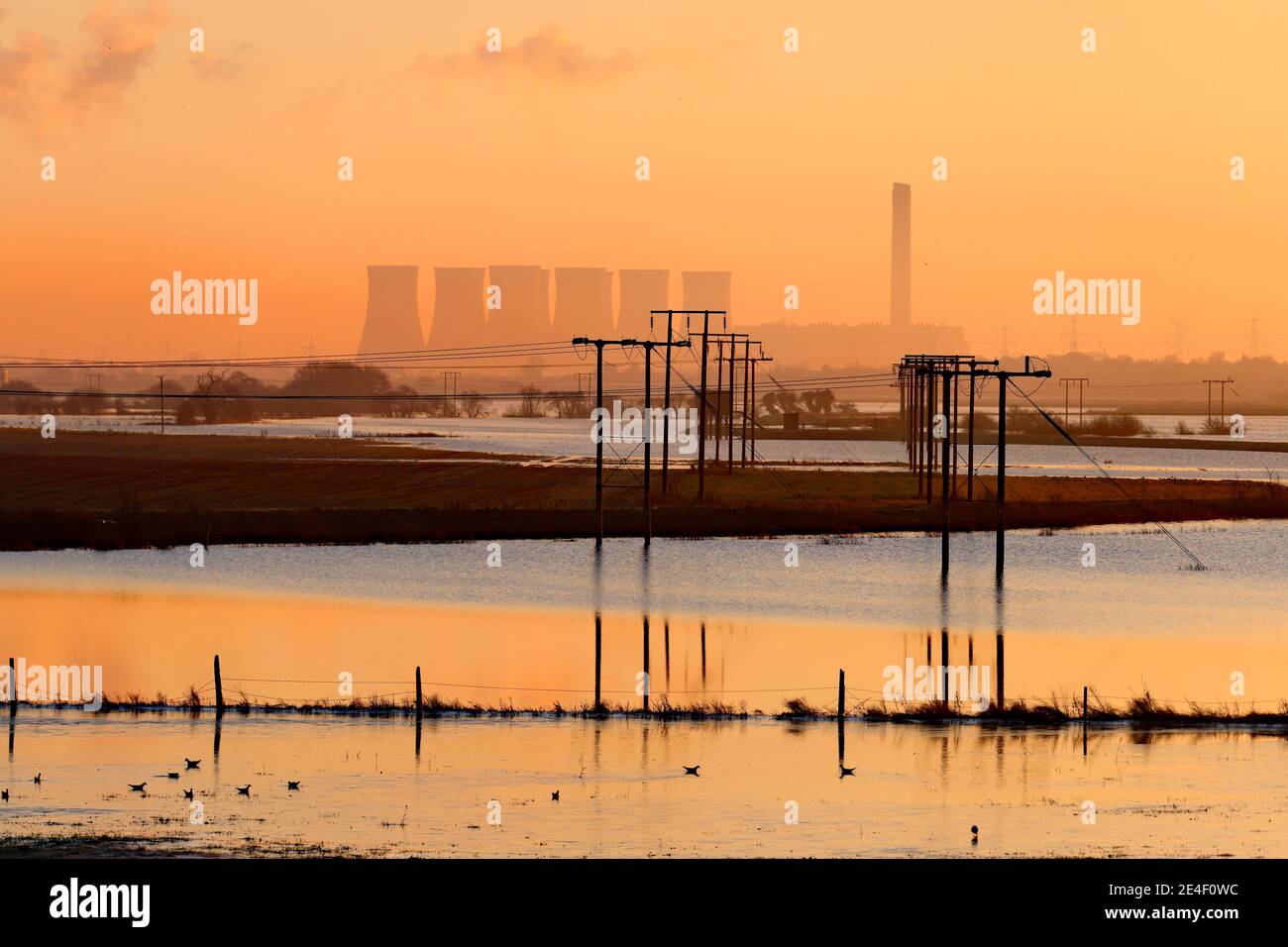 View from Ferrybridge towards Eggborough Power Station. Pylons and telegraph poles surrounded by floodwater from Storm Christoph Stock Photo