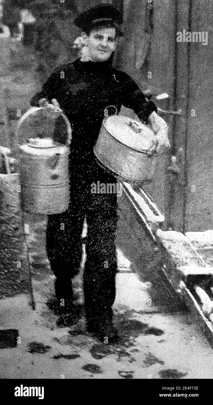 A 1940's printed photograph of a cook on a British Merchant ship, delivering the crews dinner. Stock Photo