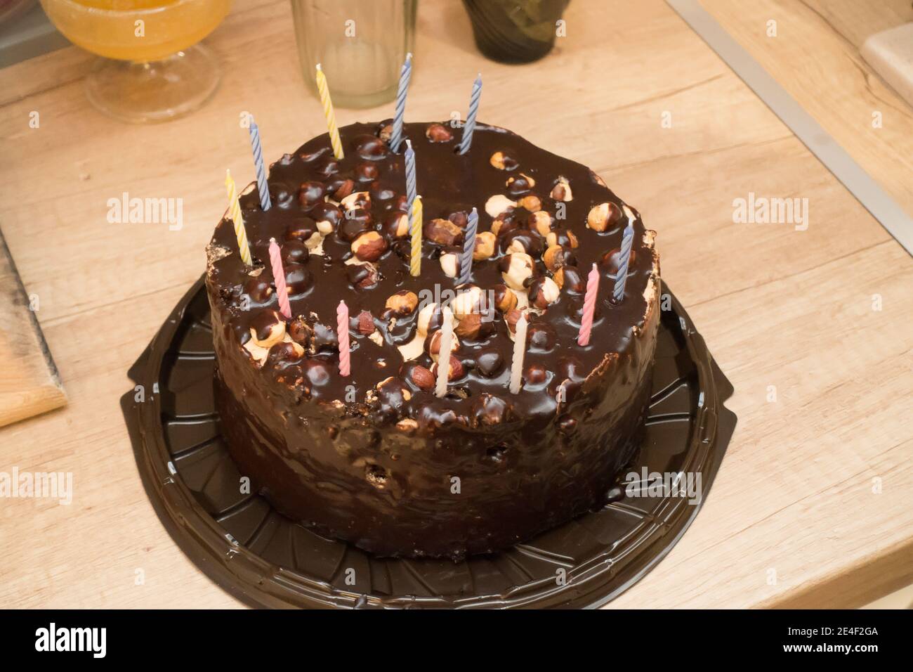 cake covered with chocolate with a few candles for a birthday party Stock Photo