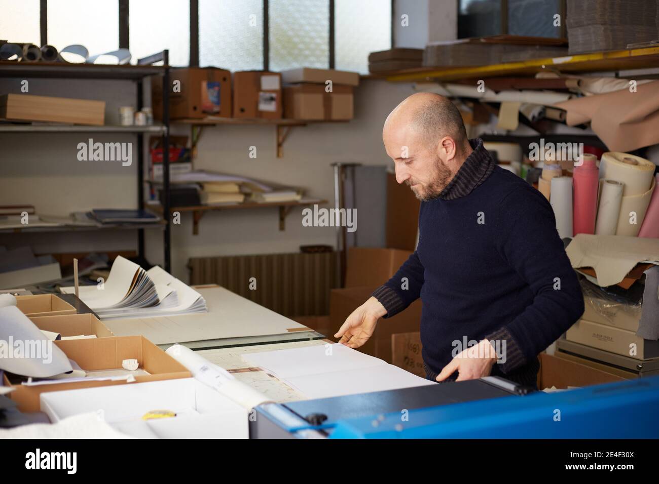 book binder working in a warehouse Stock Photo Alamy