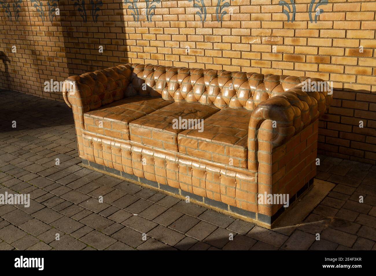 A stone couch (sofa) by artist Rodney Harris, part of the public art within a new £70m town centre redevelopment in Bicester, Oxfordshire, UK. Stock Photo