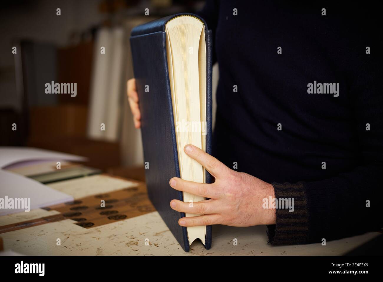 book binder working in a warehouse Stock Photo Alamy