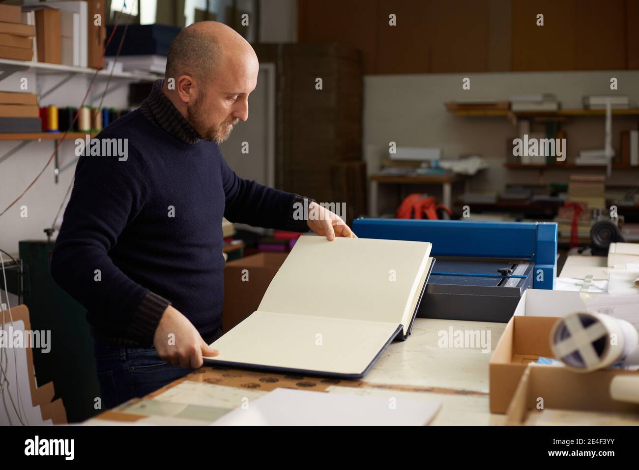 book binder working in a warehouse Stock Photo Alamy