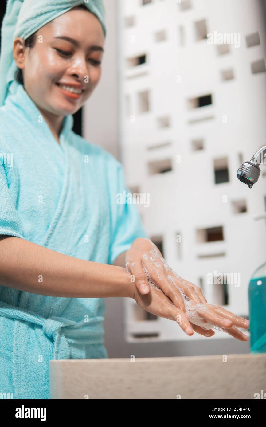 Asian girls use bath towels wash their hands with soap until foamy in the sink Stock Photo Alamy