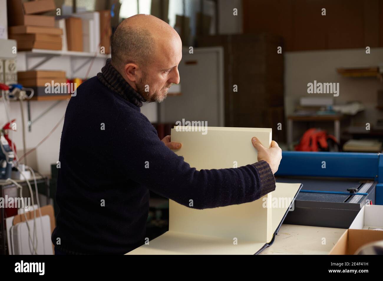 book binder working in a warehouse Stock Photo Alamy