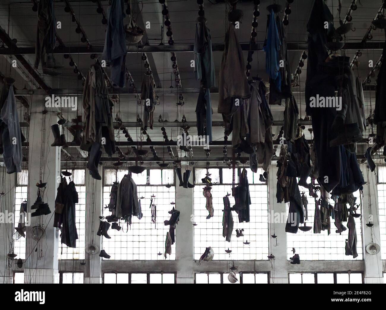 Locker room of an old industrial factory Work clothes hanging from the ceiling Stock Photo Alamy