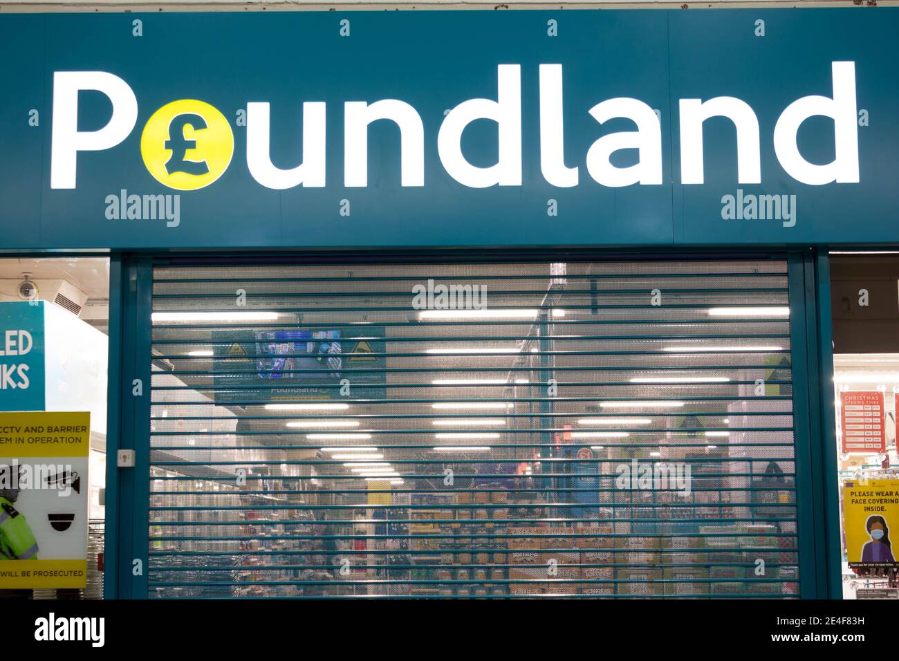 Entrance to Poundland shop shut  with shutter closed Stock Photo
