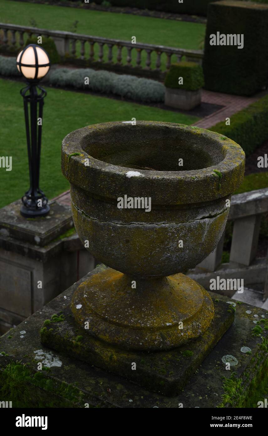 An empty cracked plant urn and lit lamp outside Hatley Castle on Vancouver Island, British Columbia, Canada Stock Photo