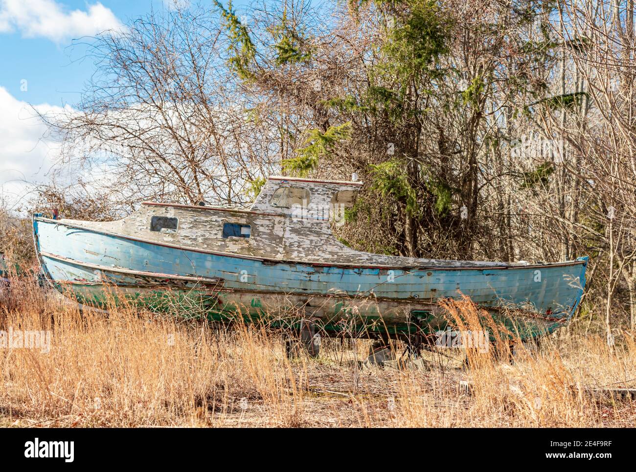 An old wooden boat sitting on blocks Stock Photo