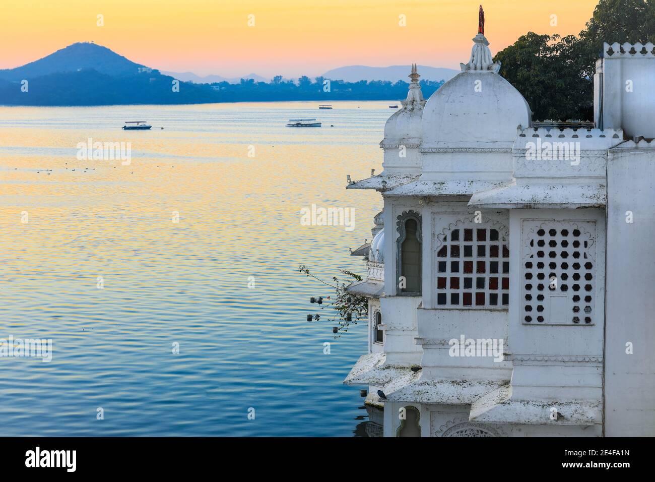 Taj Lake Palace on lake Pichola at sunrise in Udaipur Rajasthan India. Stock Photo