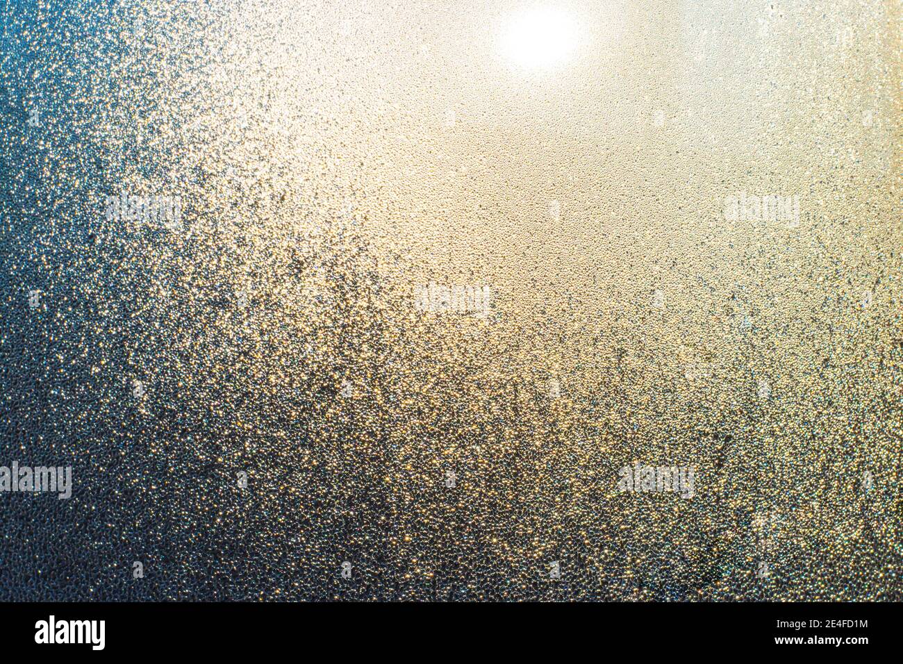 Misted window with drops of moisture that glows in the sun.Texture ...