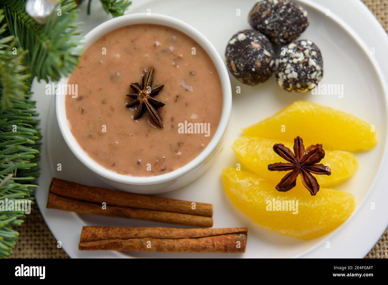 Plum pudding with a hint of orange with spicy date truffles, close-up Stock Photo