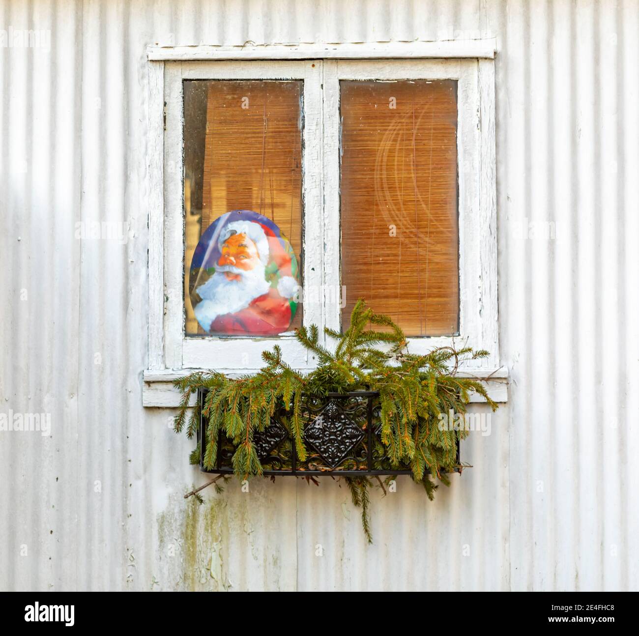 Image of Santa Claus in the window of an old house Stock Photo
