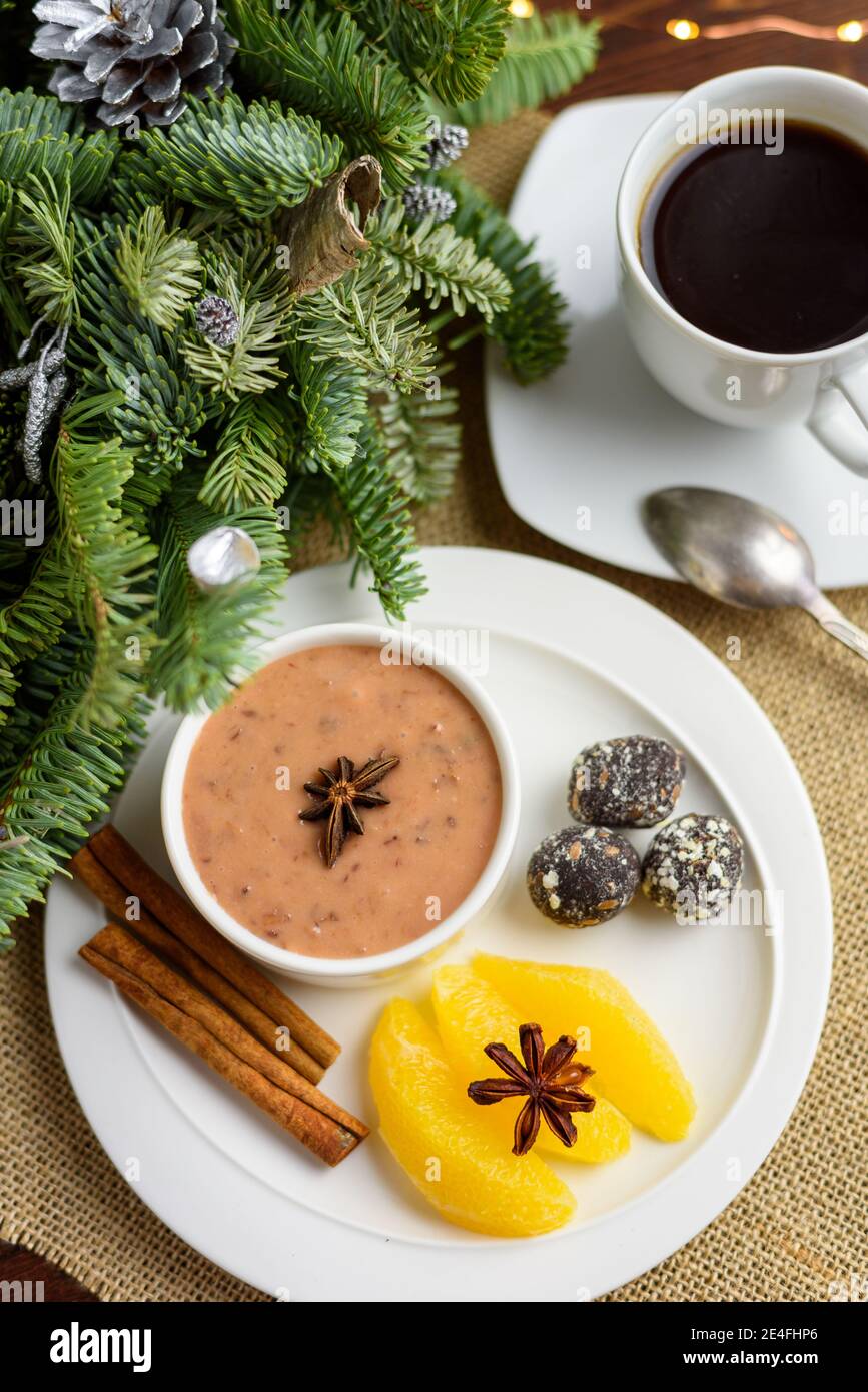 Plum pudding with a hint of orange with spicy date truffles, flat lay Stock Photo