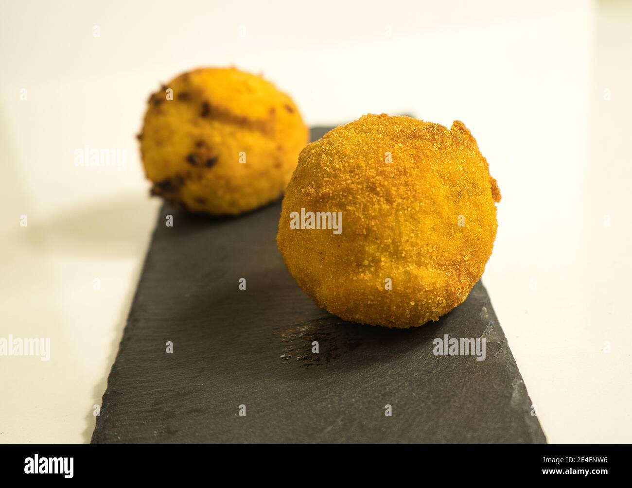 Italian appetizer arancini, rice balls stuffed with meat cooked in deep