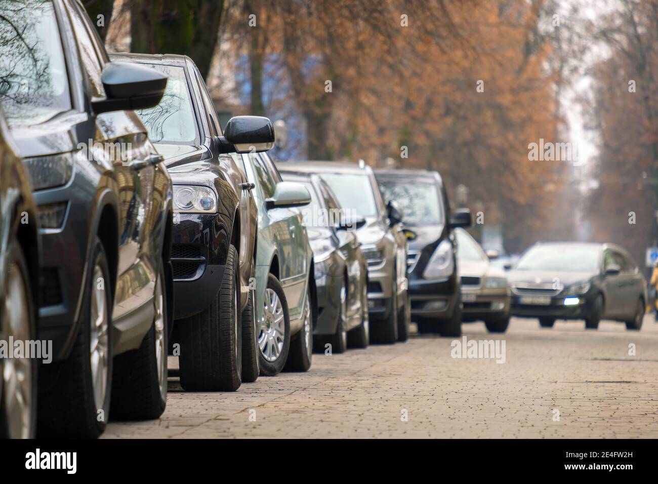 Cars parked in a row on a city street side Stock Photo - Alamy