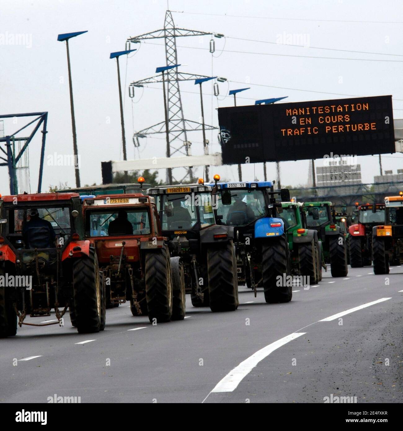 French farmers row with their tractors on October 16, 2009 on the Lille's ring road, northern France, to slow down the traffic in order to protest against their living conditions and the fall in prices of agricultural products. Farmers are holding a natio Stock Photo