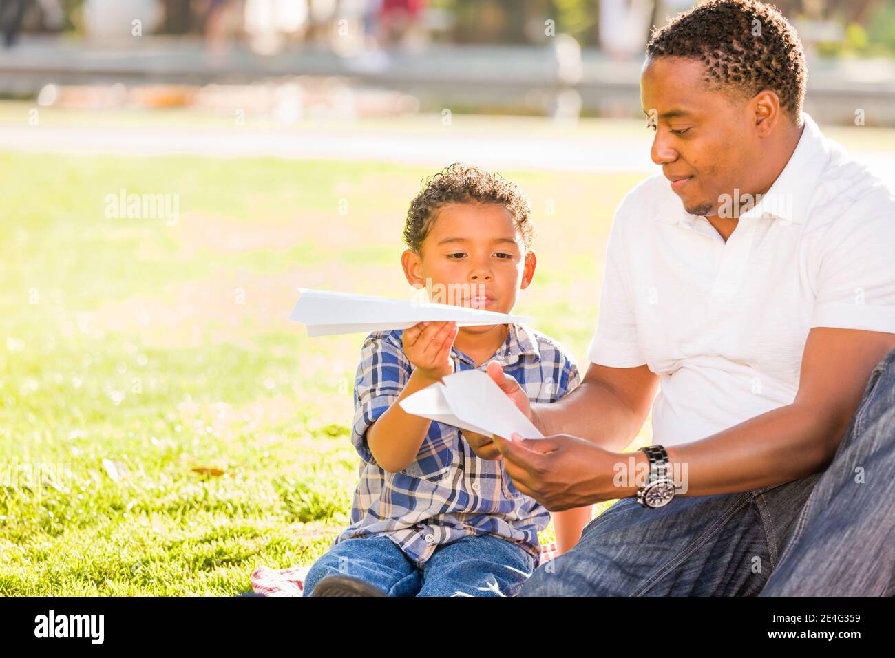 Happy African American Father and Mixed Race Son Playing with Paper ...