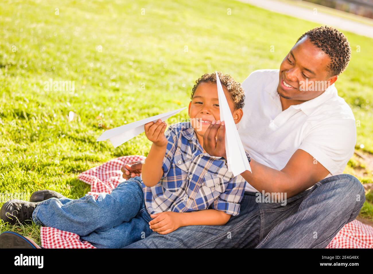 Happy African American Father and Mixed Race Son Playing with Paper ...