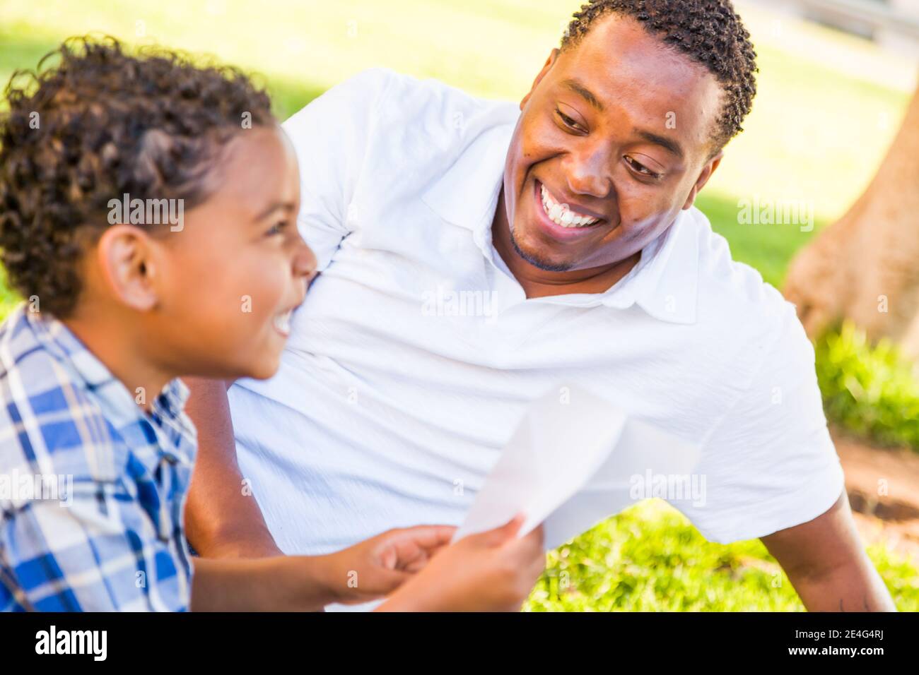 Happy African American Father and Mixed Race Son Playing with Paper ...