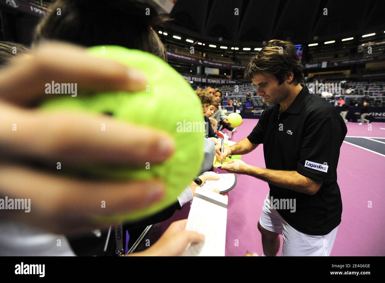 French tennis player Fabrice Santoro signs autographs during the Lyon Tennis Grand Prix in Lyon