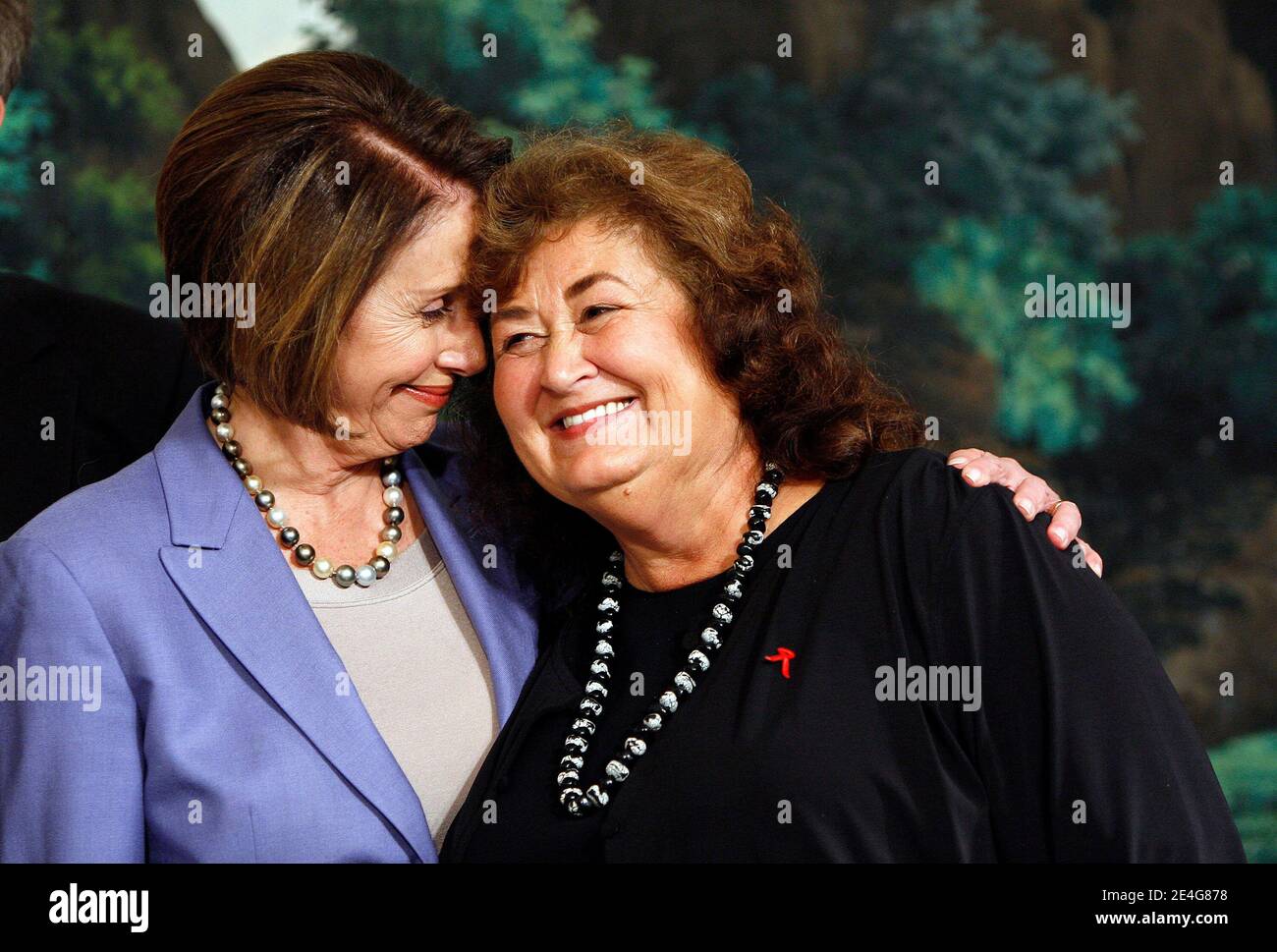 Speaker of the House, Nancy Pelosi (l) holds Ryan White's mother Jeanne before President Barack Obama signs the Ryan White HIV/AIDS treatment extension act of 2009 in the Diplomatic Room of the White House in Washington, DC, USA on October 30, 2009 Photo by Aude Guerrucci/ABACAPRESS.COM Stock Photo