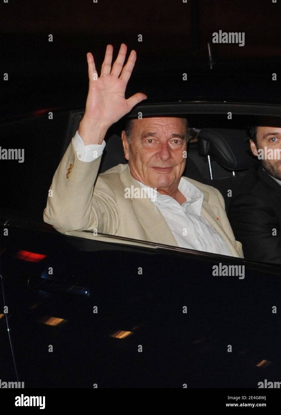 Former French president Jacques Chirac gestures as he arrives at his Paris apartment on October 31, 2009. Chirac will be the first former French president to be tried for corruption, officials said, after charges from his years as mayor of Paris returned to taint the twilight of his long career. Chirac stands accused of giving political allies lucrative bogus jobs as city hall 'ghost workers' and his trial will be the latest in a series to expose graft and dirty tricks at the highest levels of state. Photo by Mousse/ABACAPRESS.COM Stock Photo