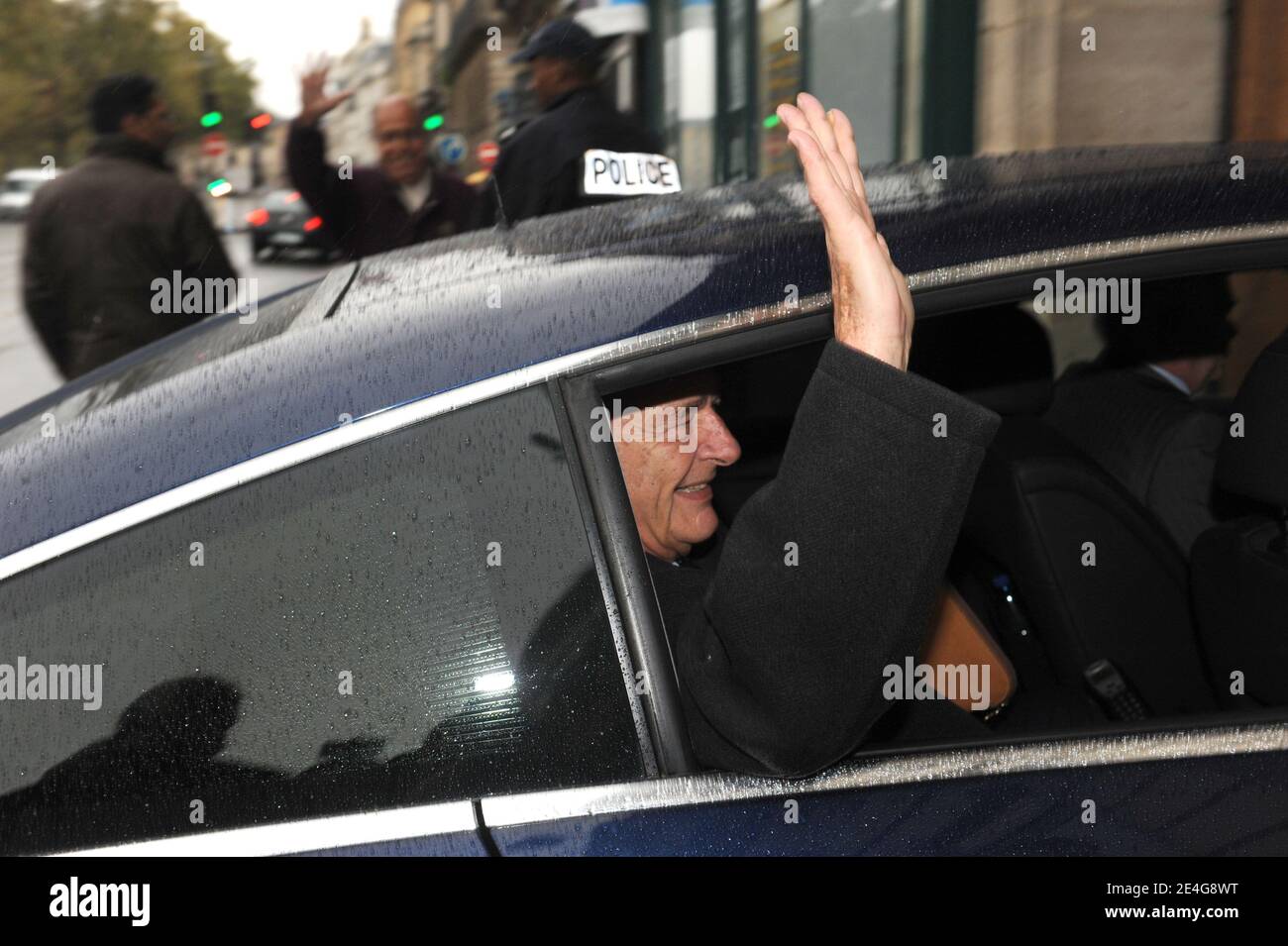 Former French president Jacques Chirac gestures as he arrives at his Paris apartment on November 1, 2009. Chirac will be the first former French president to be tried for corruption, officials said, after charges from his years as mayor of Paris returned to taint the twilight of his long career. Chirac stands accused of giving political allies lucrative bogus jobs as city hall 'ghost workers' and his trial will be the latest in a series to expose graft and dirty tricks at the highest levels of state. Photo by Mousse/ABACAPRESS.COM Stock Photo