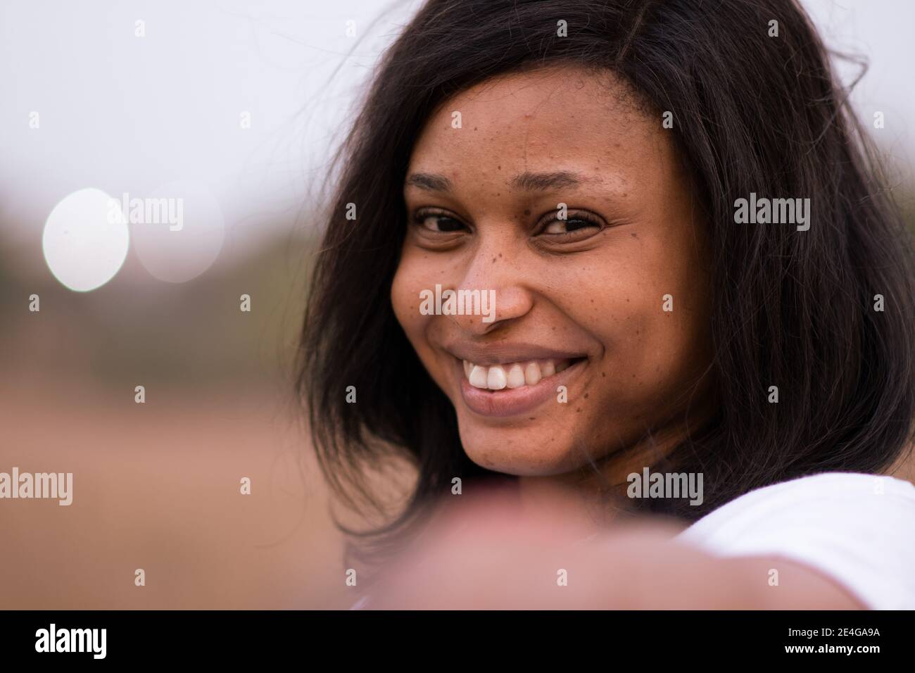 close up portrait of a beautiful young african woman smiling and ...